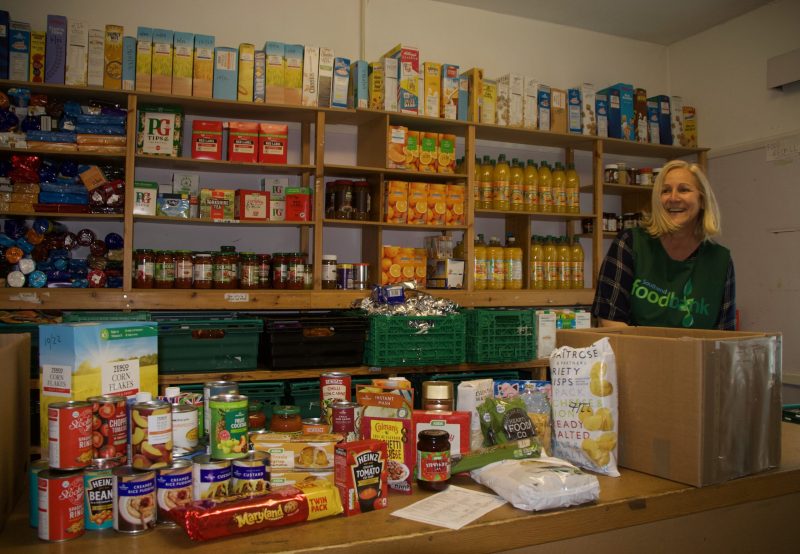 A volunteer stands with goods donated to the Southend Foodbank